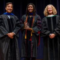Faculty standing with Provost
